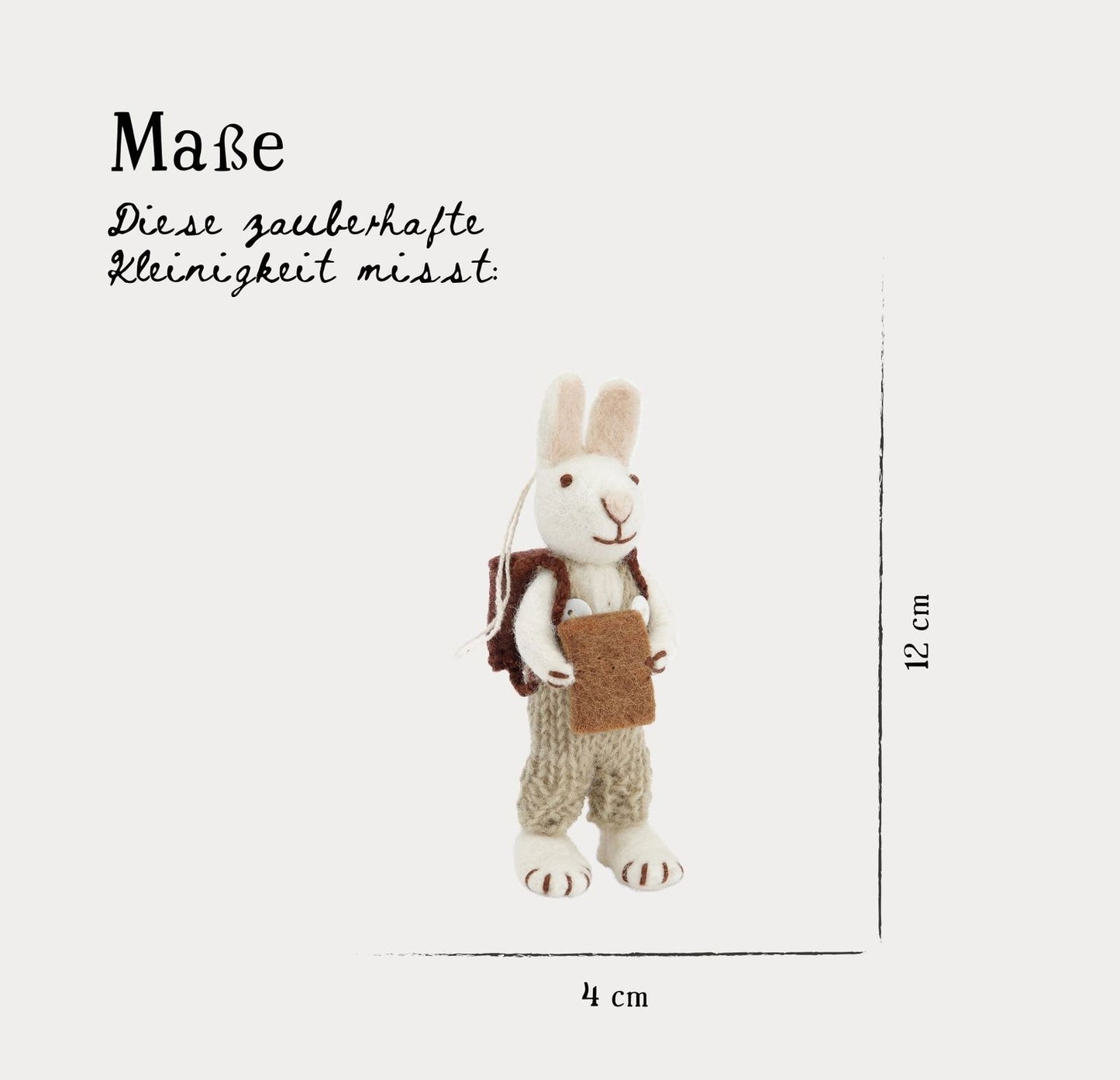 Weißer Hase mit grüner Hose und Buch