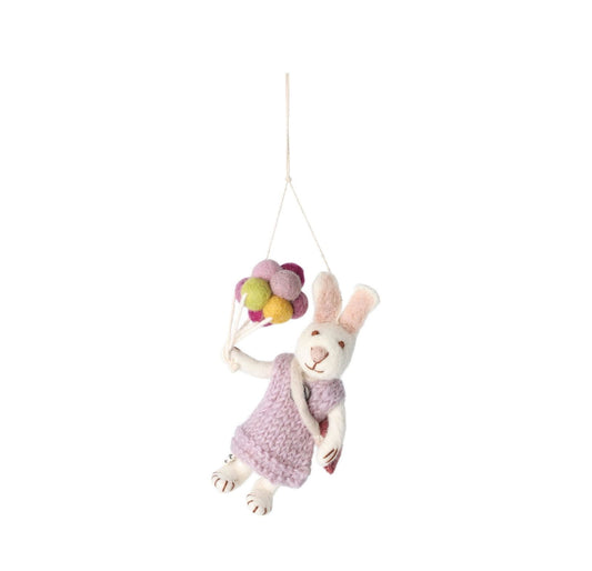 Weißes Hasenmädchen oder Hase mit Lavendelkleid und Ballons